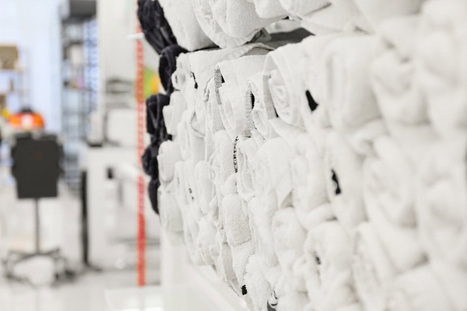 Clean white salon towels stacked on a shelf in a professional Chicago barbershop or beauty salon